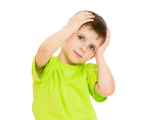 Portrait of a little boy who is holding his head with hands , cl