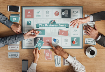 Business people playing a board game