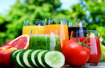 Glasses with fresh organic detox juices in the garden