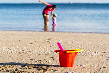 Plastic baby bucket on beach