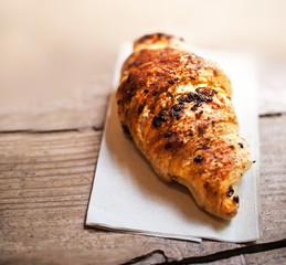 ..Chocolate croissant close up. Fresh and tasty croissant over w