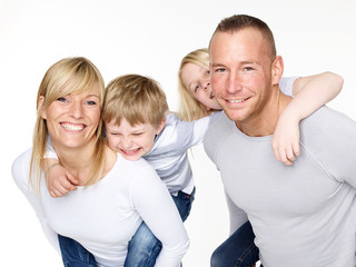 Parents giving piggyback ride to children