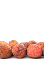 Ripe lychee fruits over white background