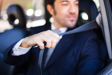 Portrait of an handsome man on his car