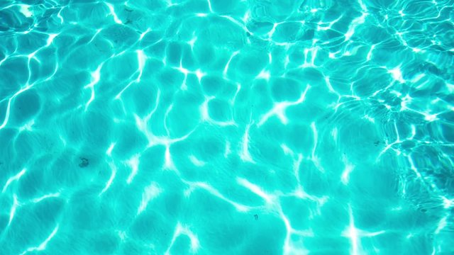 Shining blue water ripple background. Aqua texture.