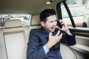 Angry man screaming at the phone