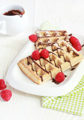 Belgium whole wheat waffles with raspberries and chocolate decor