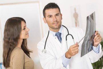 Doctor showing X-ray result to patient
