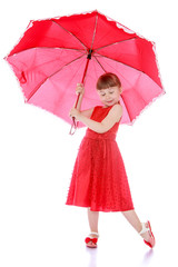 Stylish little girl in a long red dress 