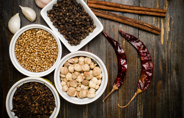 Herbs and spices on wooden background, food seasoning