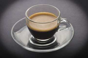 Cup of coffee on the black background