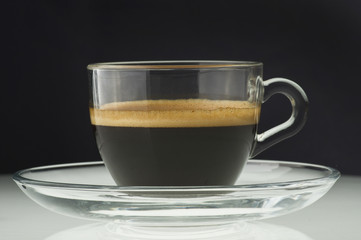 Cup of coffee on the black background