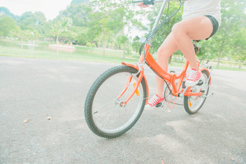 woman riding a bicycle in park