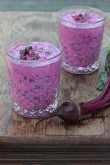 Closeup of a glass of cold beetroot soup.