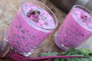Closeup of a glass of cold beetroot soup.