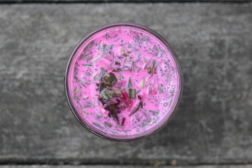 Closeup of a glass of cold beetroot soup.