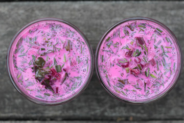 Closeup of a glass of cold beetroot soup.