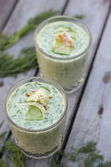 Closeup of glasses of cold cucumber and dill soup.