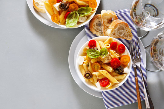 Healthy summer light pasta salad with fresh raw tomatoes, anchov
