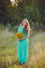 Artistic portrait of young gorgeous brunette on green meadow. 