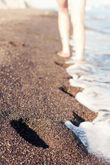Footprints in the black sand