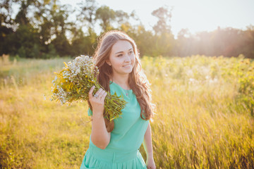 Artistic portrait of young gorgeous brunette on green meadow. 