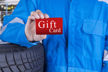 Workshop worker holds a gift card