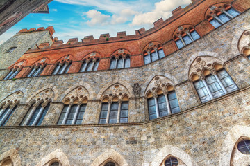 Chigi-Zondadari Palace in Siena under a blue sky