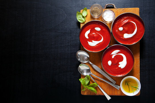 healthy tomato soup with fresh basil leaves . salt & pepper. on