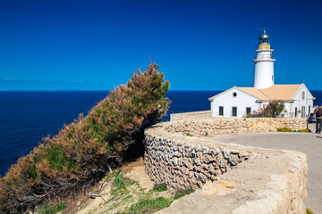 Fototapeta na wymiar small white lighthouse at Cala Ratjada