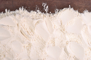 White flour on a wooden background