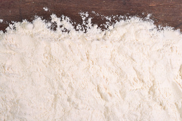White flour on a wooden background
