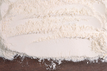 White flour on a wooden background