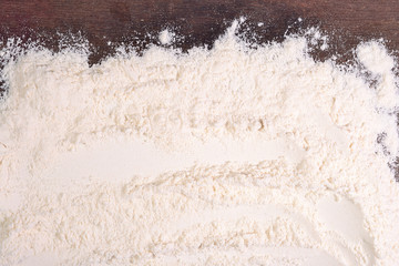 Fototapeta na wymiar White flour on a wooden background
