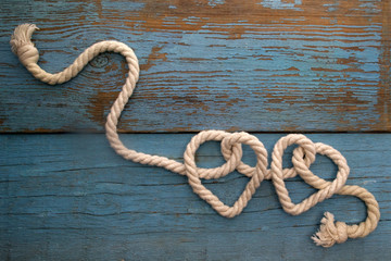 leash  rope into heart shape on wood