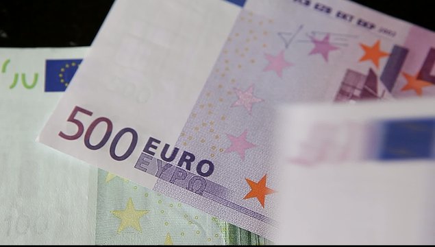 100 and 500 Euro Banknotes on dark background