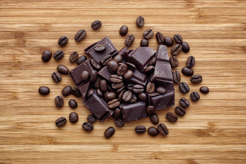 Heap of broken dark organic chocolate and coffee beans