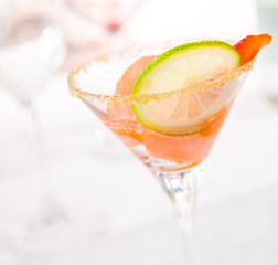 glass of caipiroska with ice cream, strawberry and lime slice
