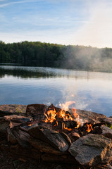 camp fire by a lake