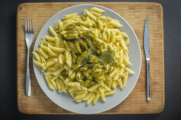 Dish of green pesto pasta penne italian food served