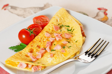 omelette with ham, cherry tomatoes and cilantro