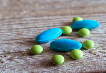 Pills scattered on wooden surface