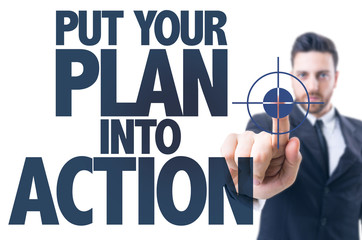 Business man pointing the text: Put Your Plan Into Action