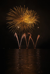 Colorful fireworks with reflection on lake.