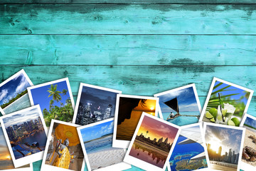 heap of travel photos on azure wood background