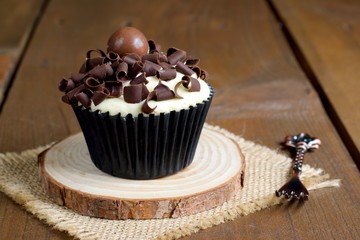 Chocolate cupcake on a rustic wooden table