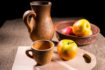 Obraz na płótnie Canvas Apples Arranged on Table with Wooden Handicrafts