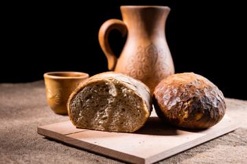 Wheat Bread on Cutting Board with Pitcher and Cup