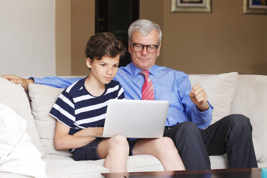 Grandfather and grandson with laptop