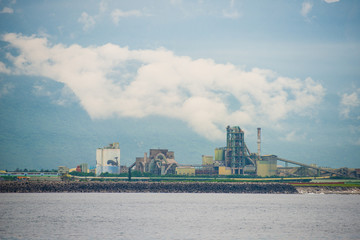Naklejka premium Old cement factory close to the sea